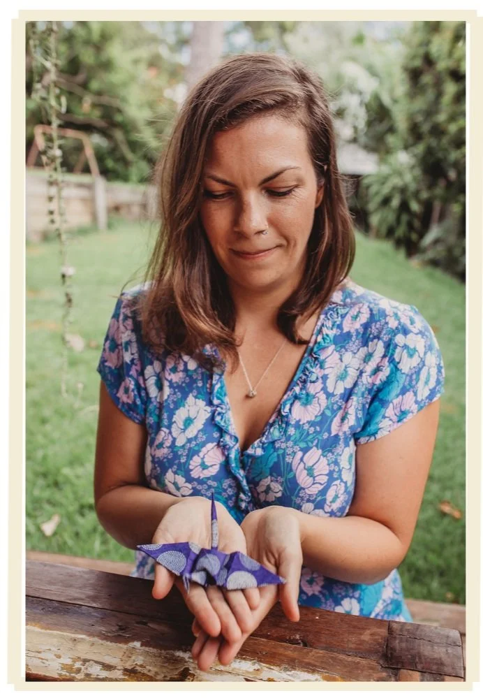 Samantha Ruckle holding an origami paper crane from her Paper Crane of Hope project